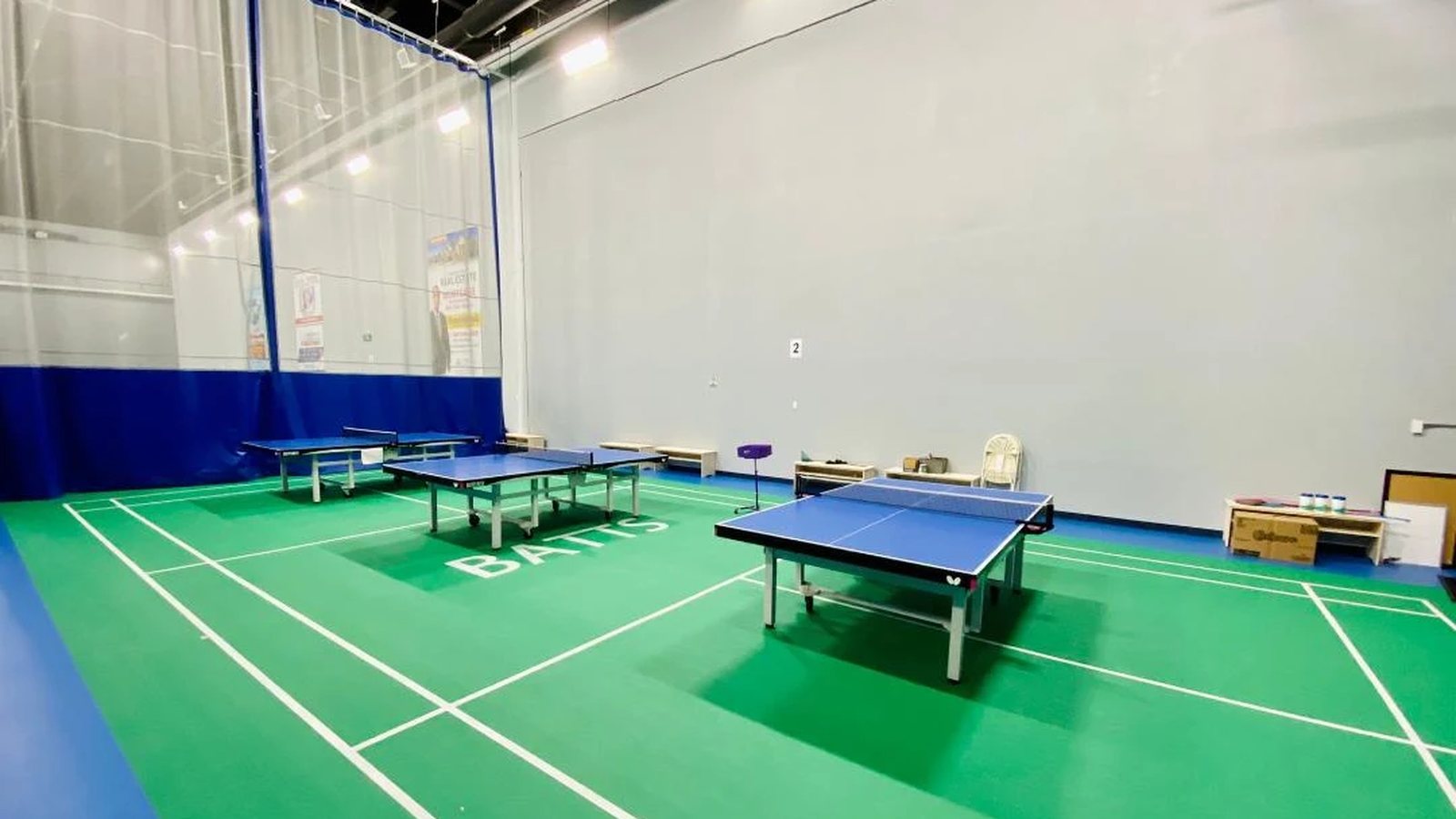 Blue table tennis tables on the BATTS-branded court at BATTS Athletic Brampton